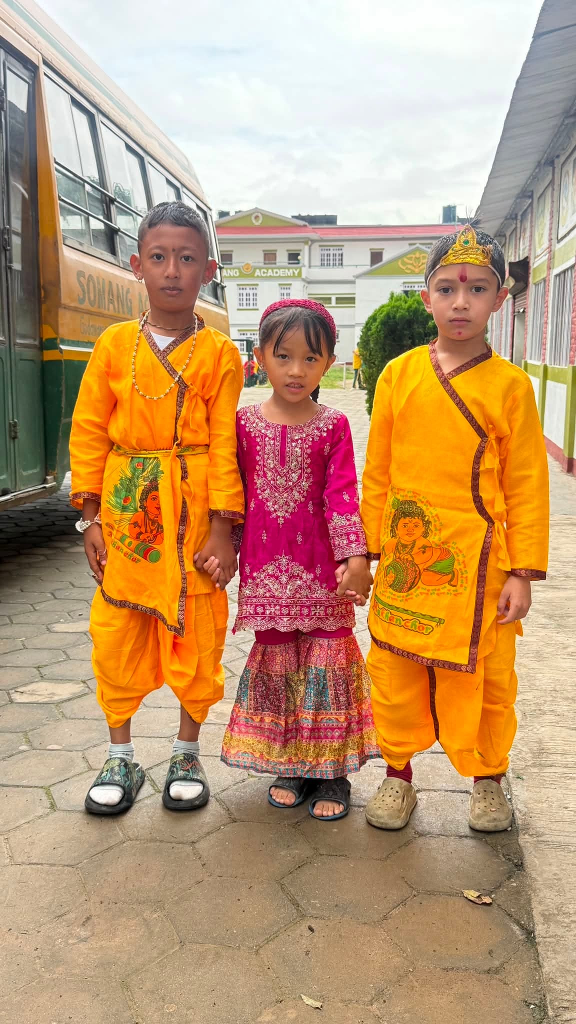 Students in traditional dress in front of the Somang Academy campus
