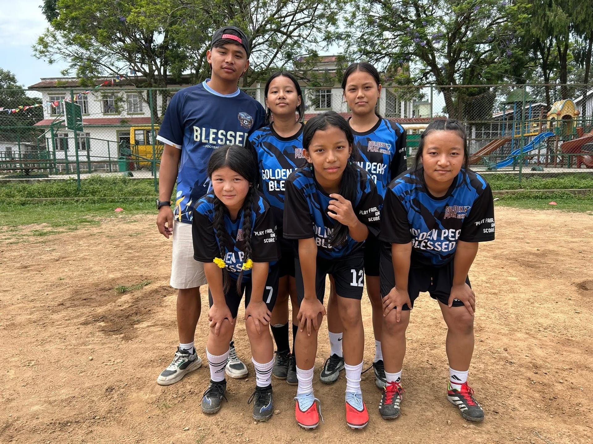Somang students in team kit on the school field
